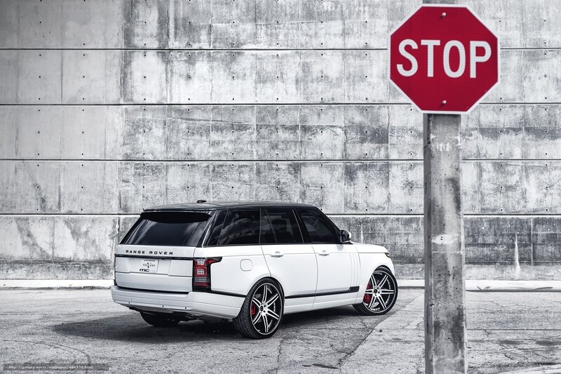 White Range Rover by stop sign