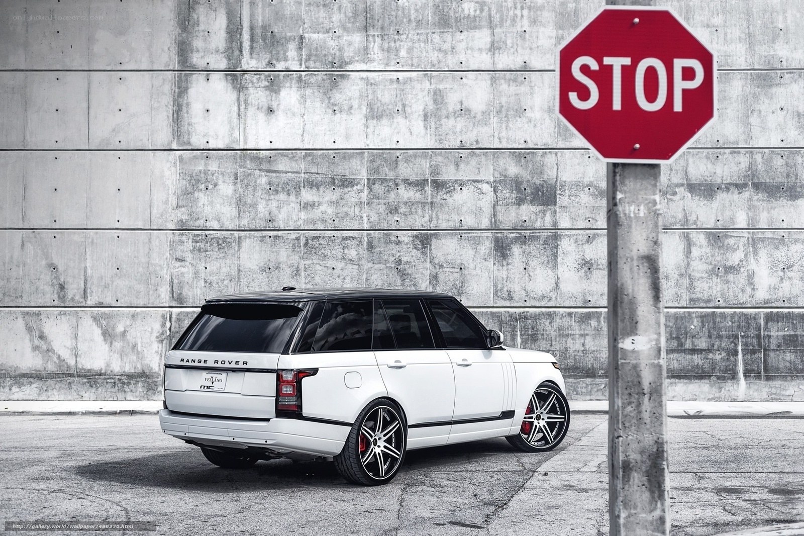White Range Rover by stop sign