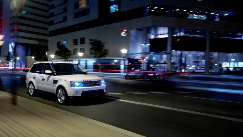 White Range Rover driving at night