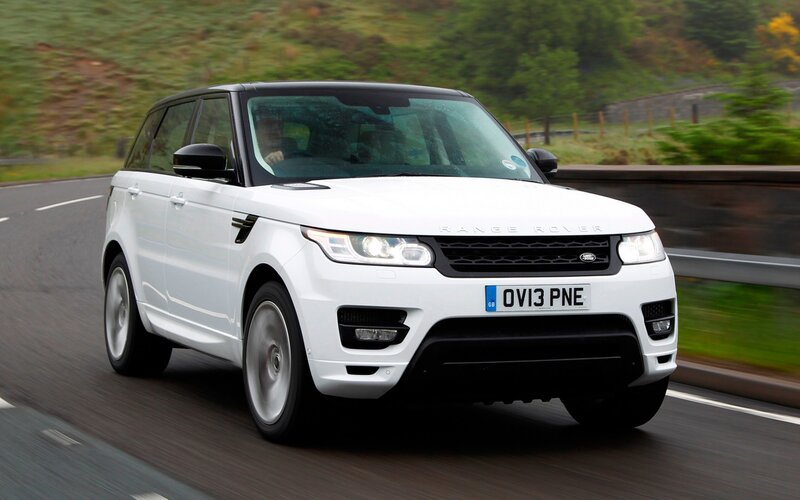 White Range Rover driving on road