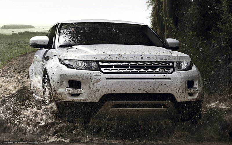 White Range Rover driving through mud