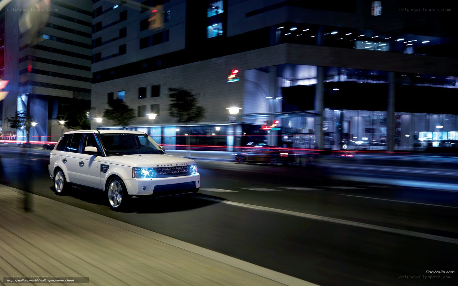 White Range Rover in city at night