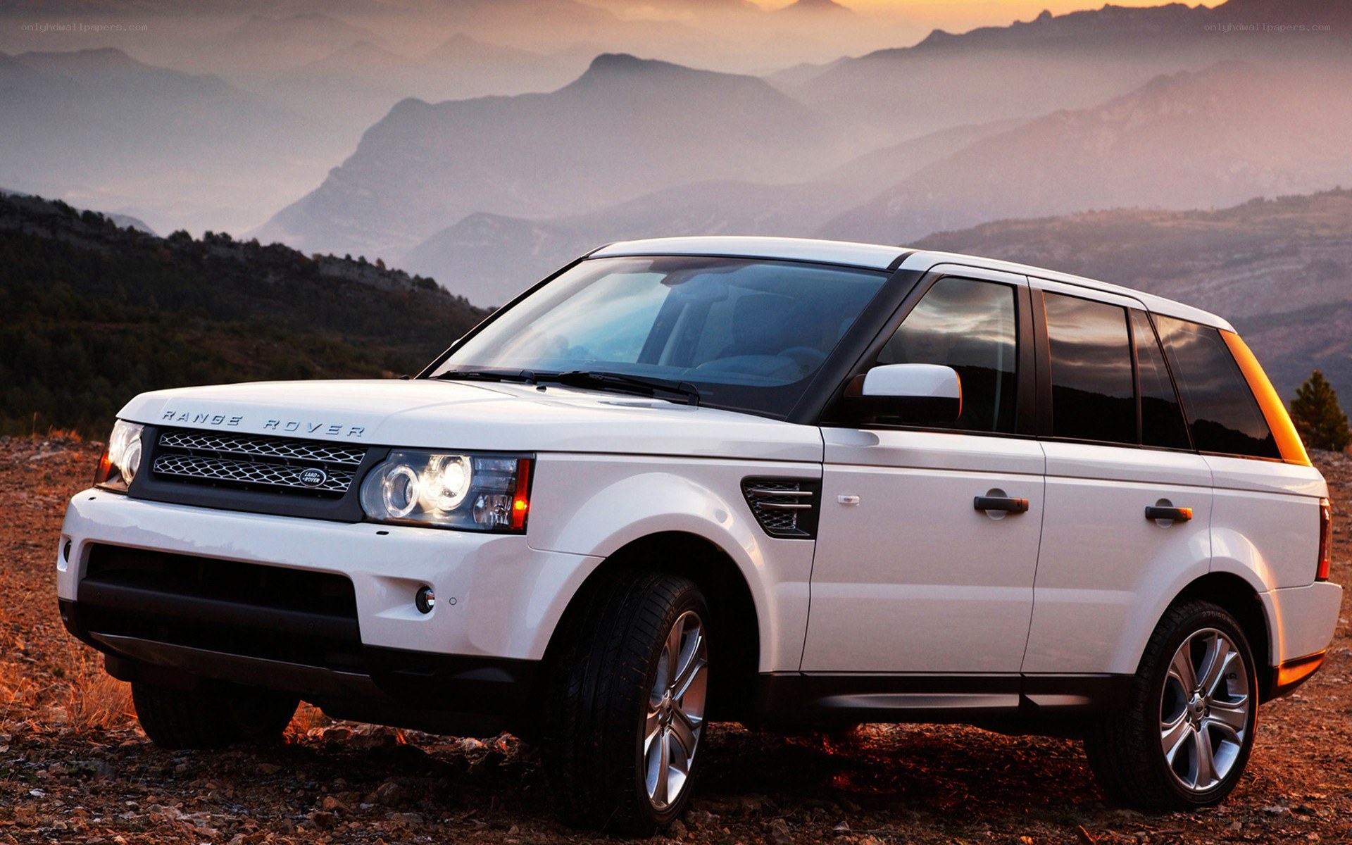 White Range Rover in mountain landscape
