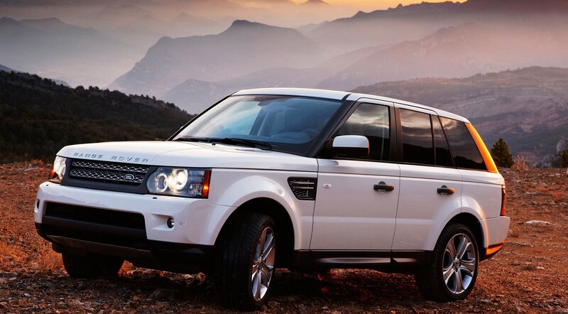 White Range Rover in mountain landscape