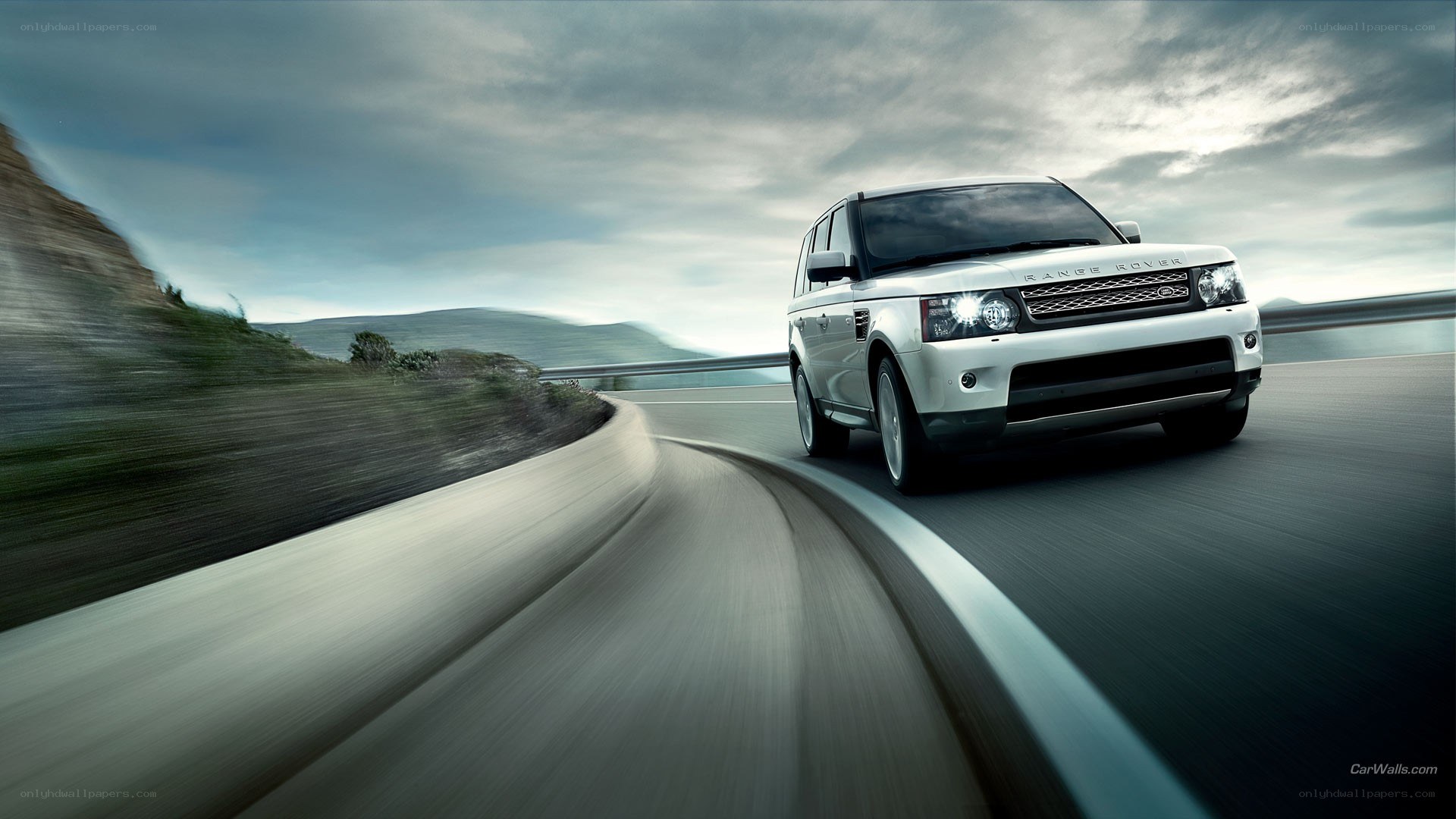 White Range Rover on a winding road