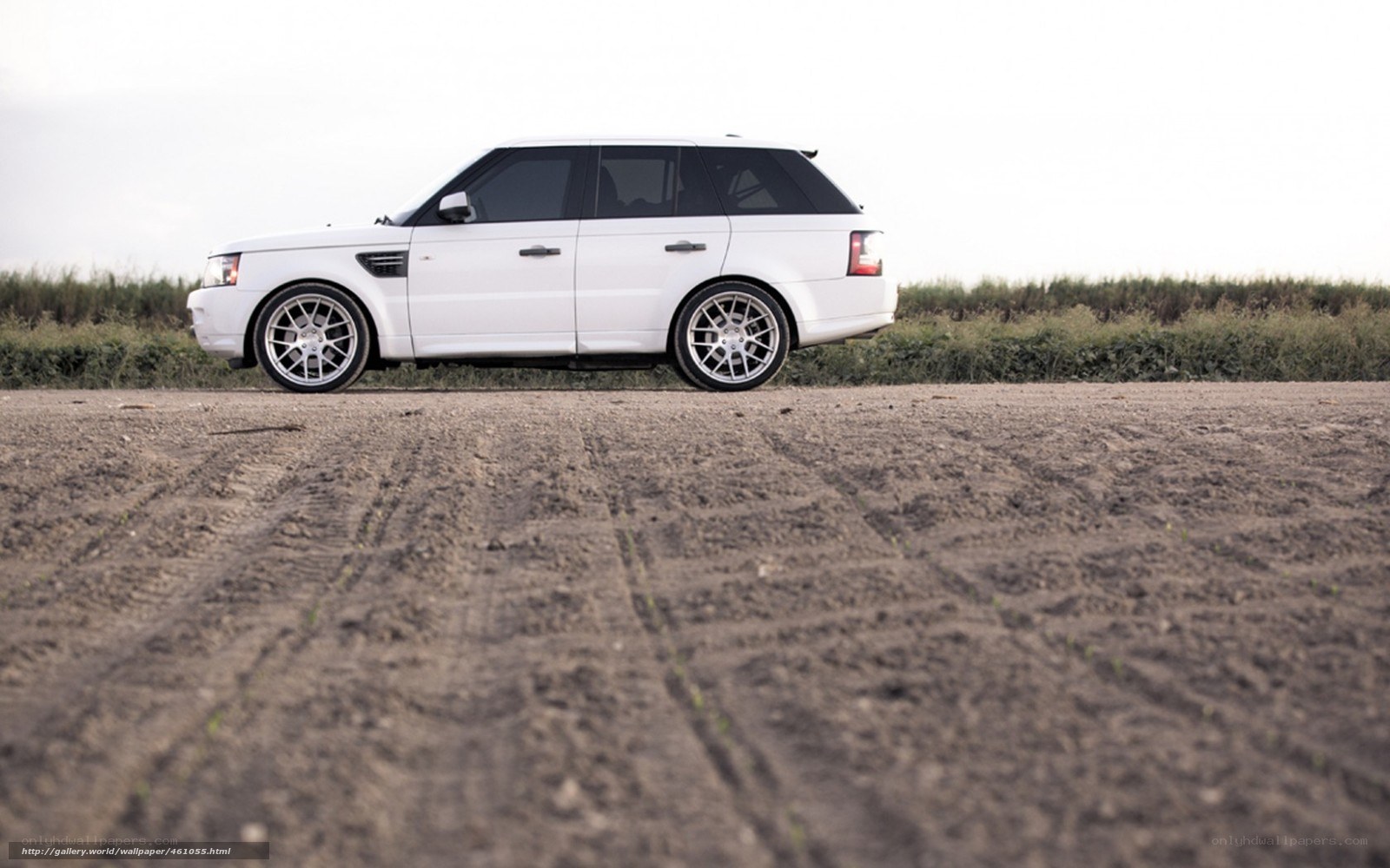 white range rover on dirt road