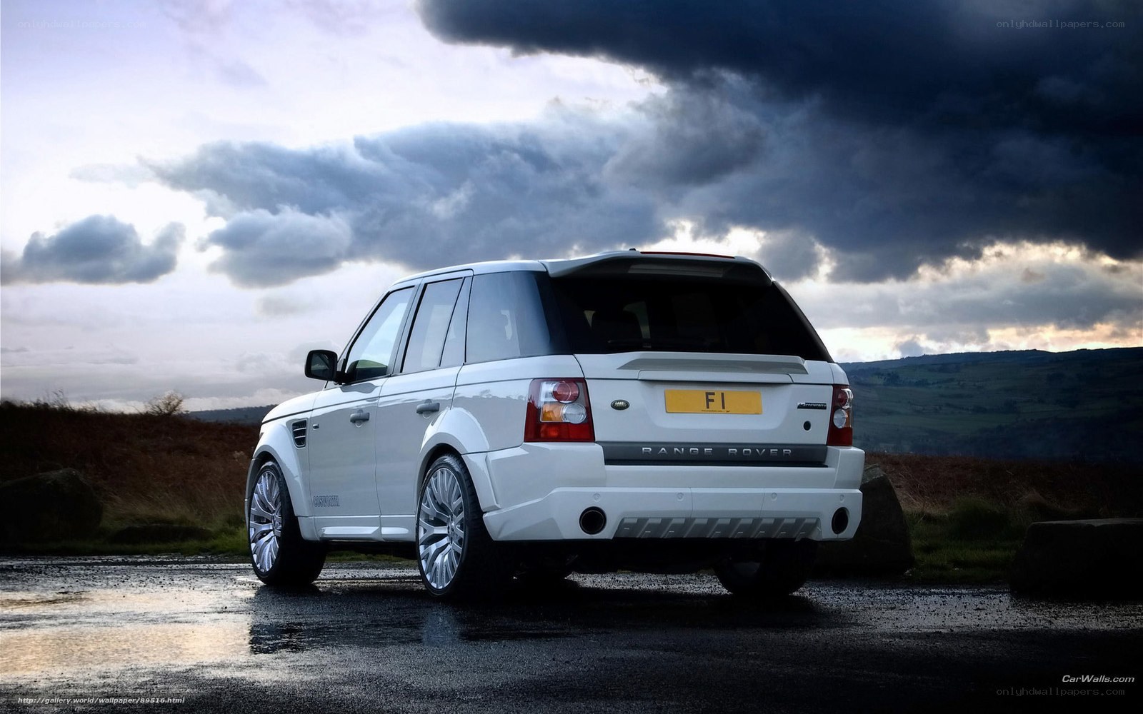White Range Rover on wet road
