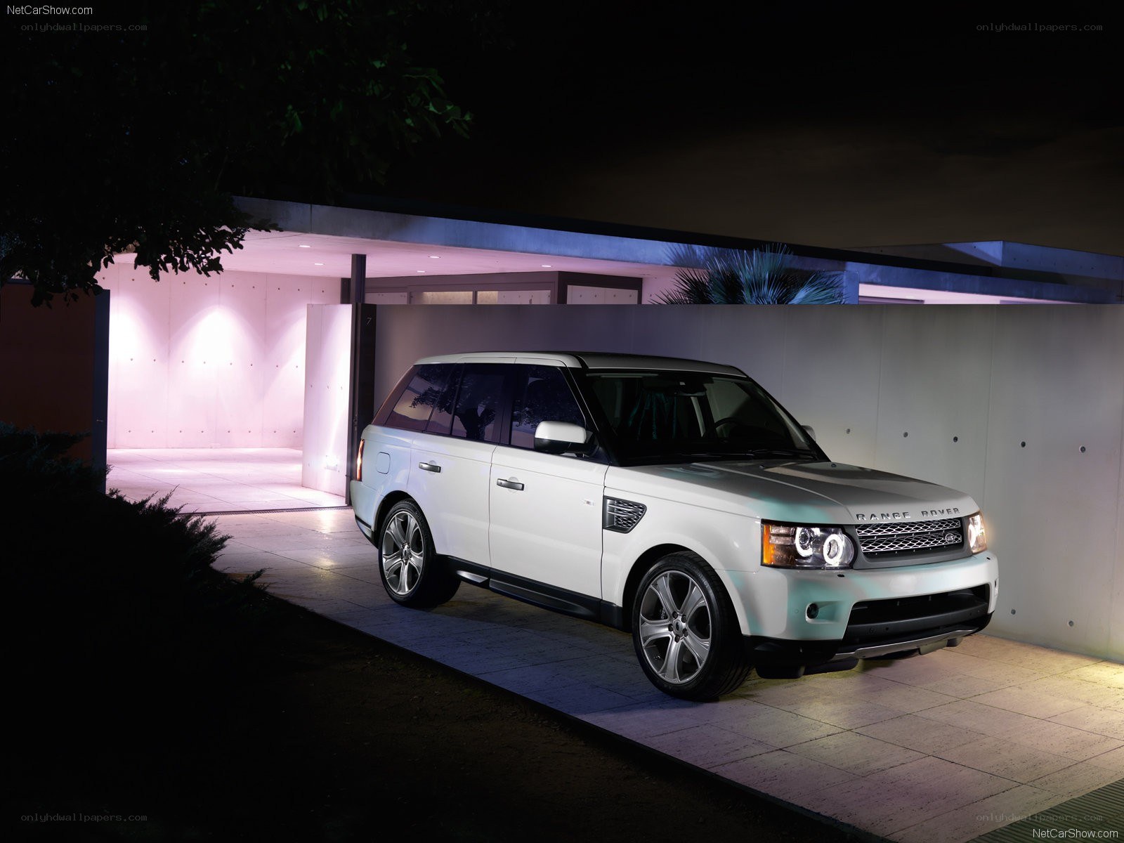 White Range Rover parked at night