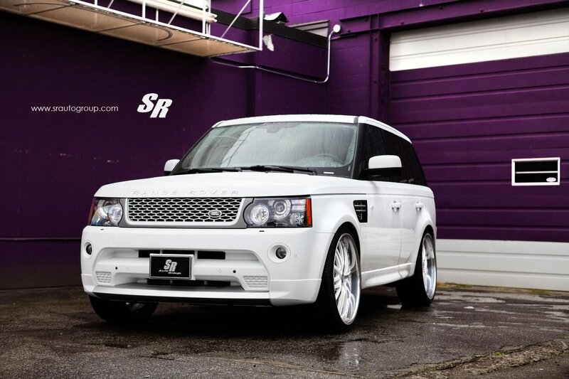 White Range Rover parked in front of purple building