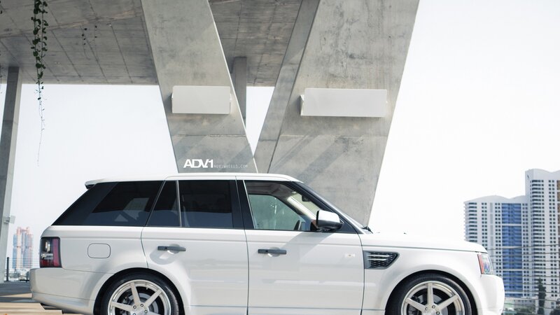 White Range Rover under bridge