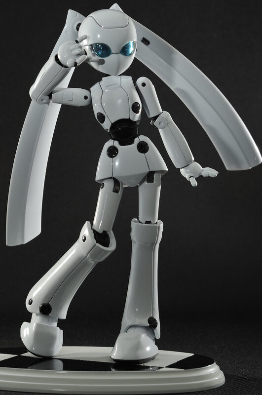 white robot figurine with blue eyes