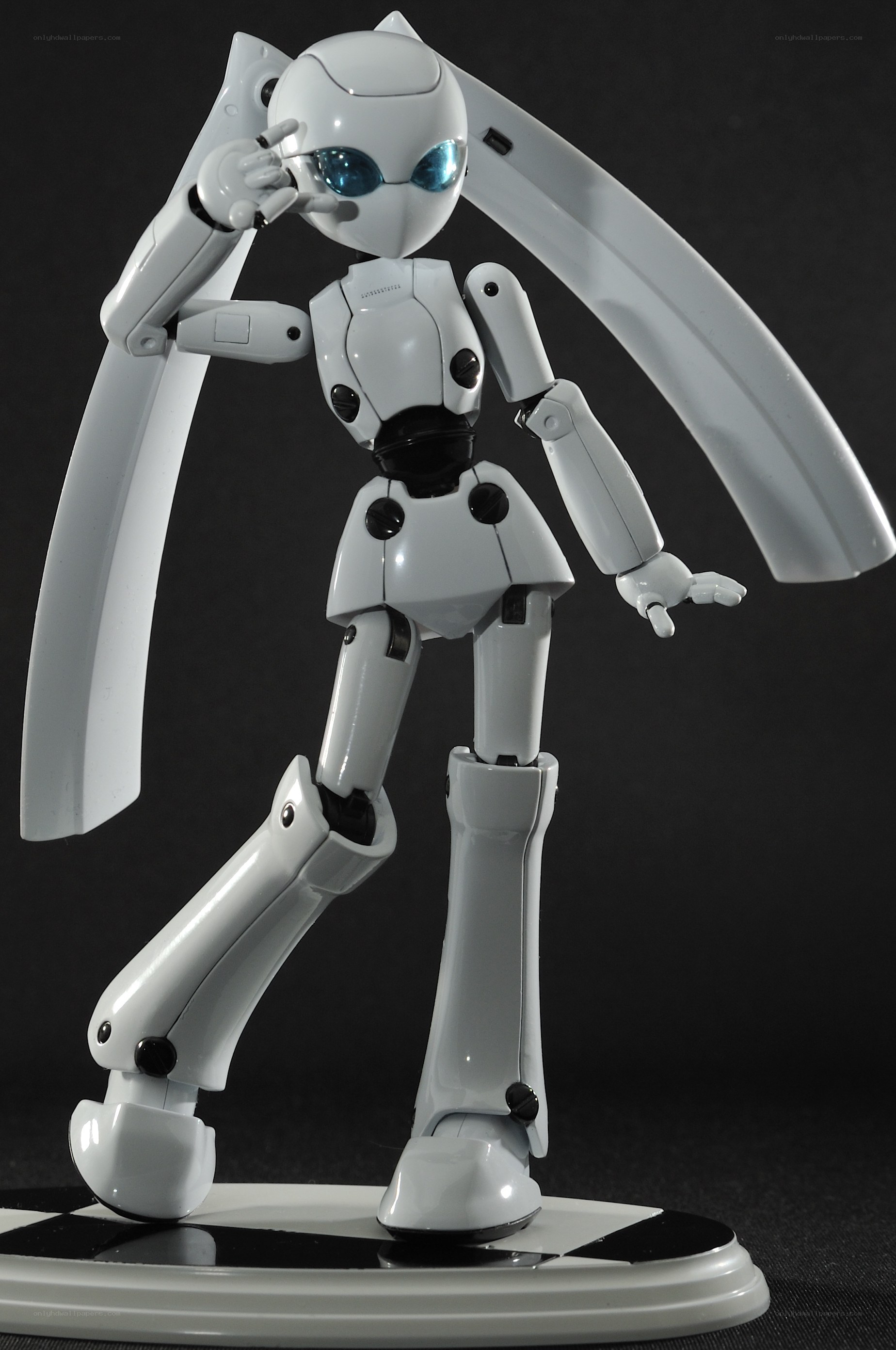 white robot figurine with blue eyes