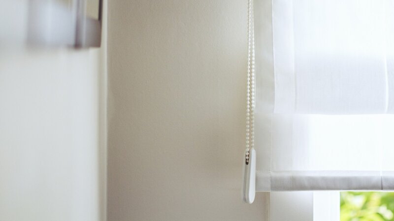 white roller blind at window