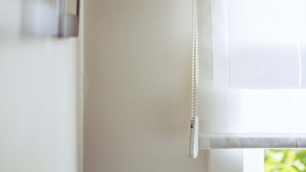 white roller blind at window