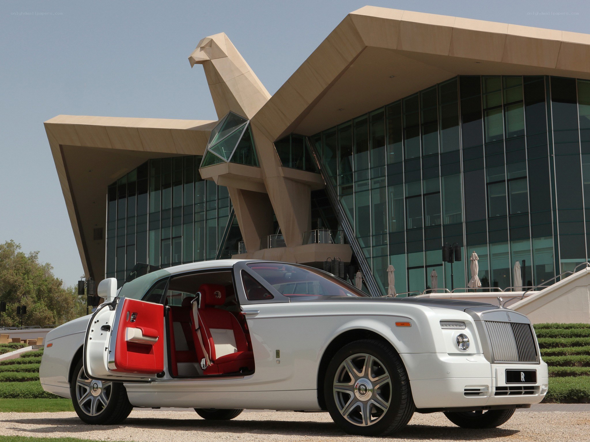 White Rolls-Royce at modern building