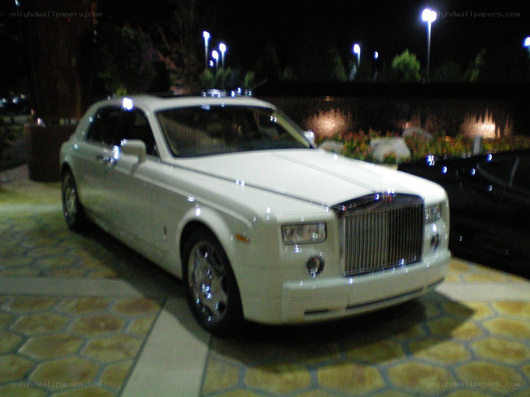 white rolls-royce at night