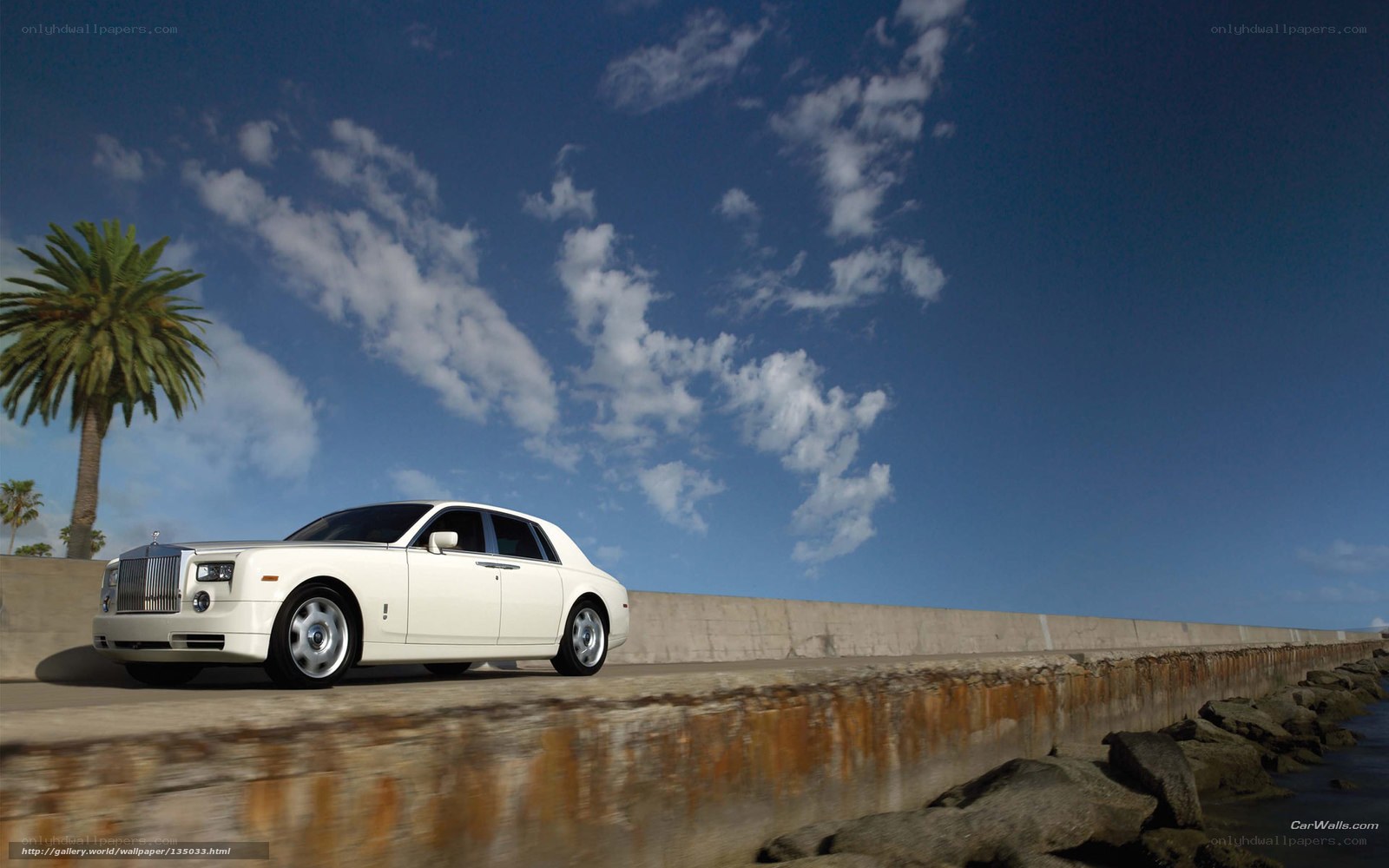 White Rolls-Royce on coastal road
