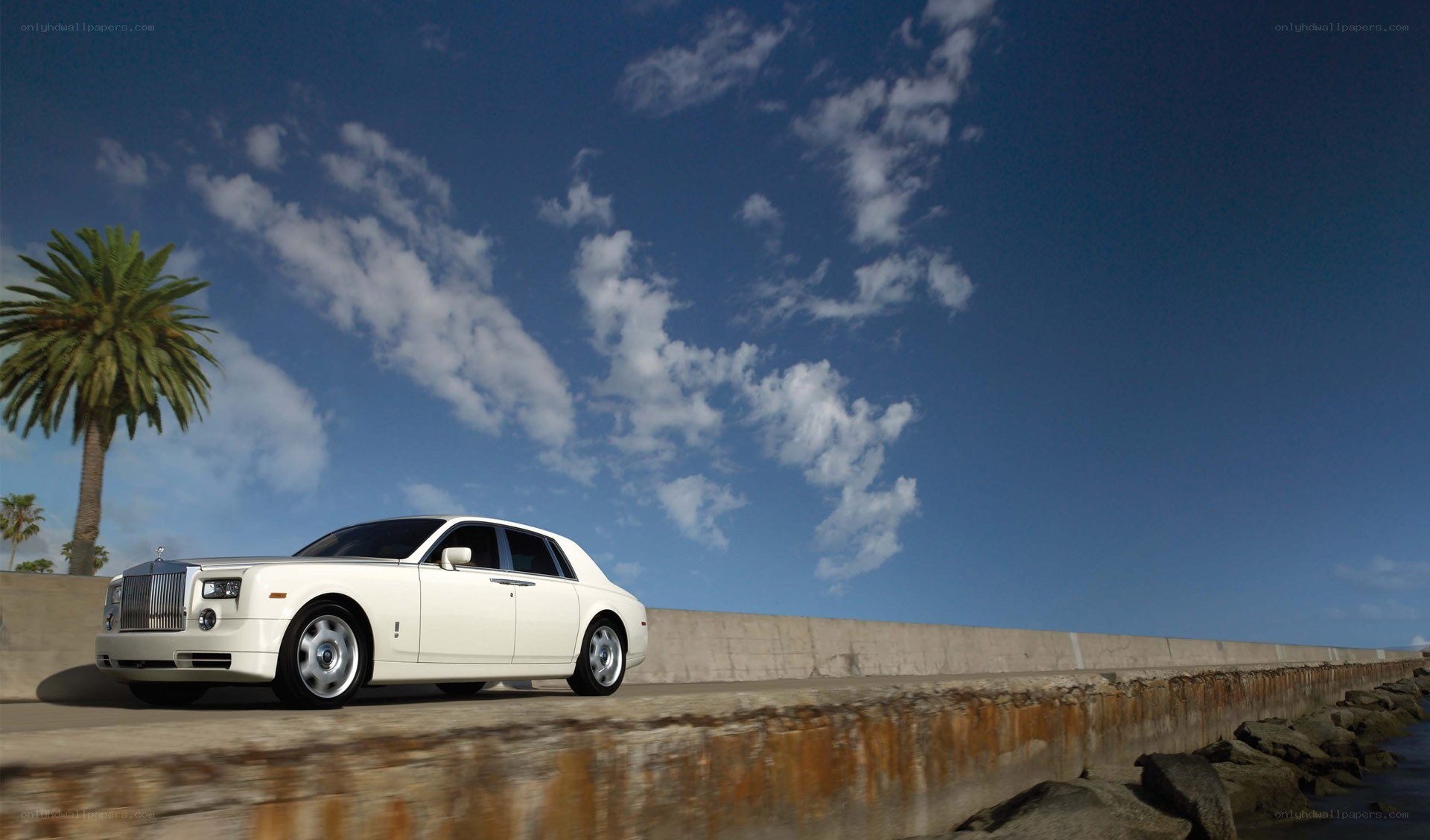 White Rolls-Royce on coastal road