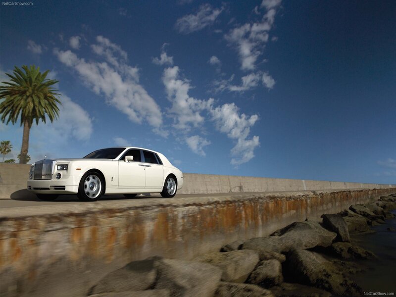 White Rolls-Royce on coastal road