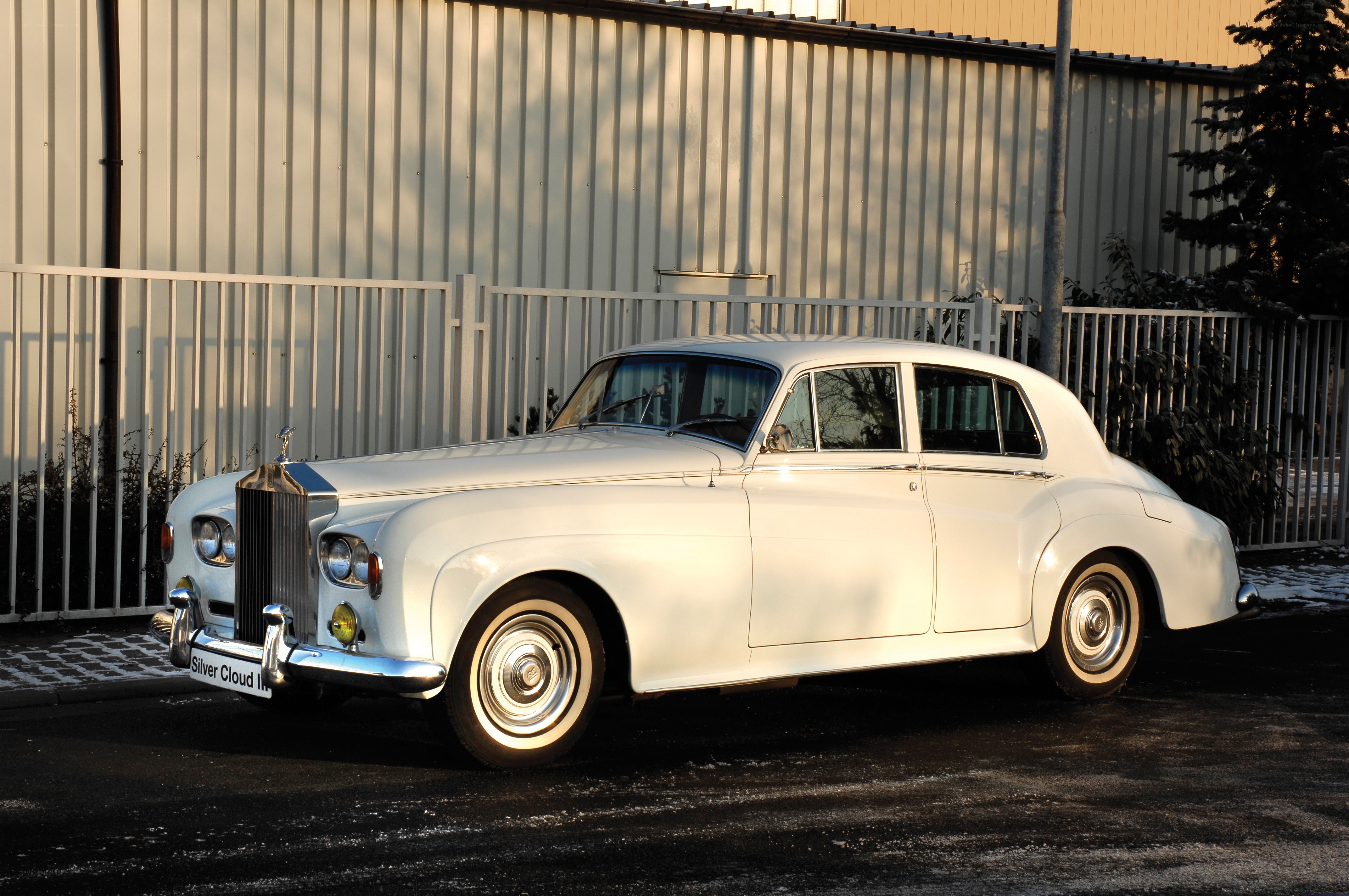 White Rolls-Royce parked outside