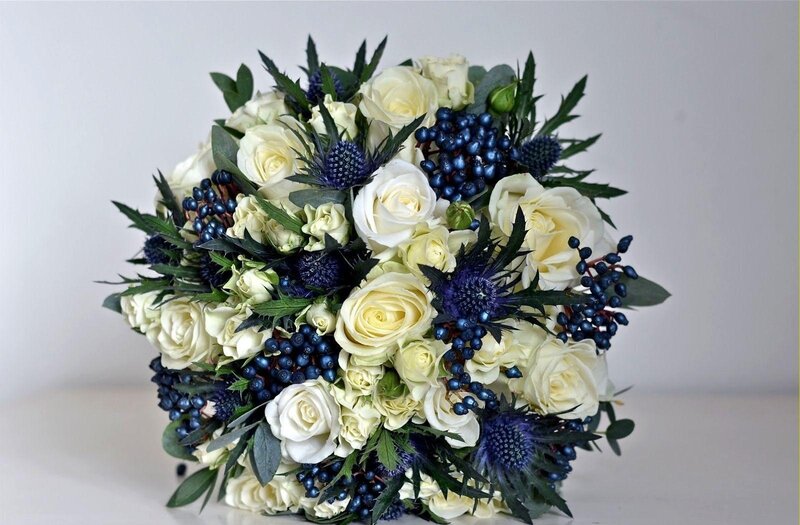 white roses and blue thistles bouquet