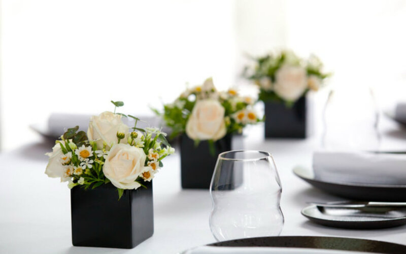 White Roses in Black Vases