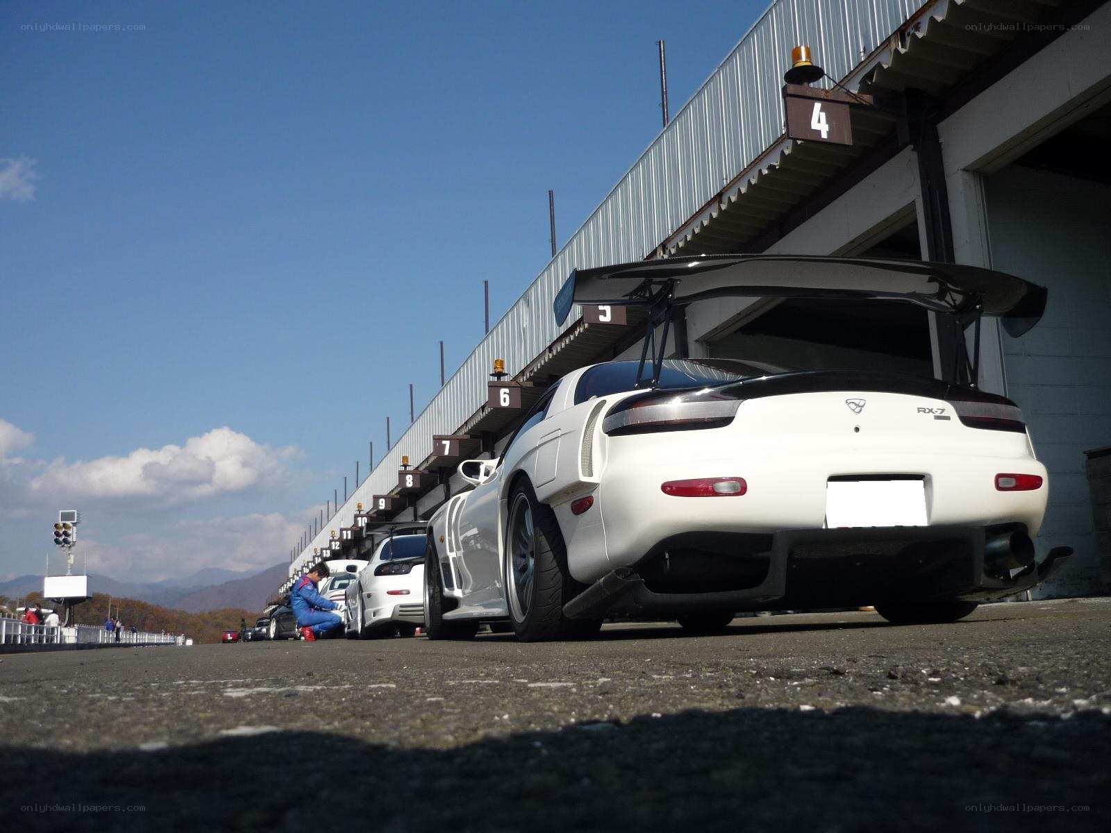 White RX-7 at racetrack