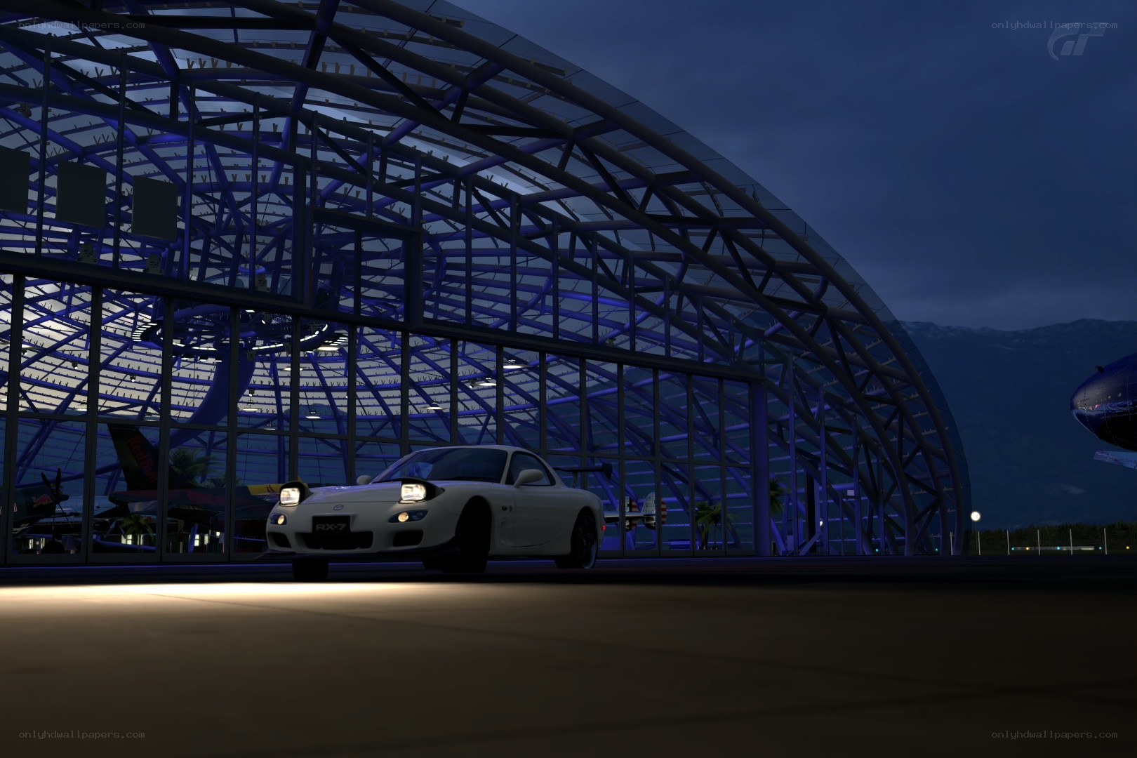 White RX-7 in hangar at night