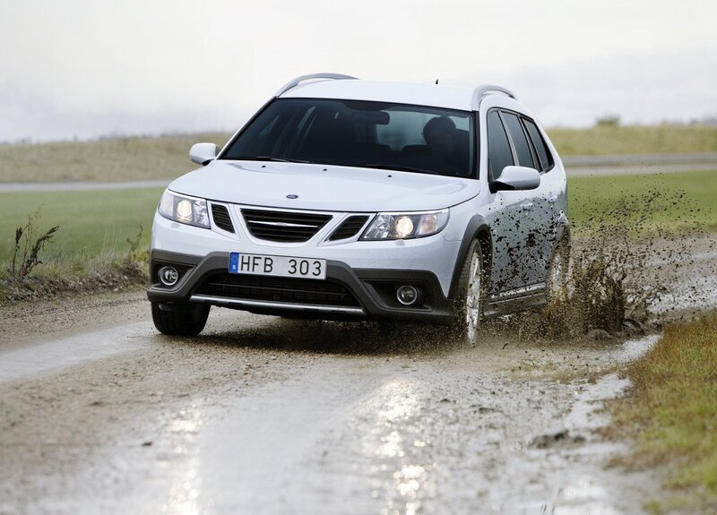White Saab driving on muddy road