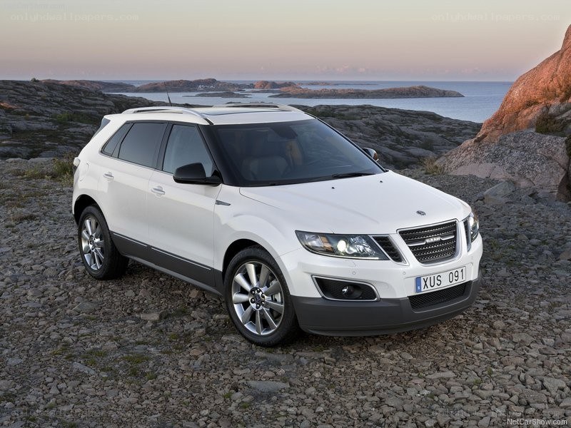 White Saab SUV on rocky shore