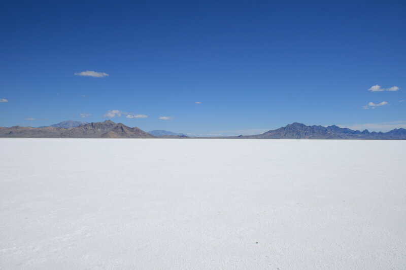 White salt flat with mountains