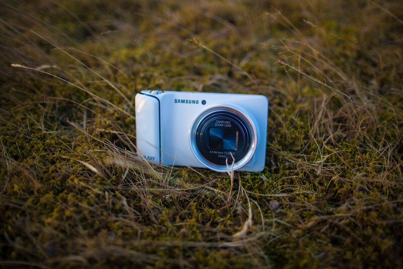 White Samsung camera in grass