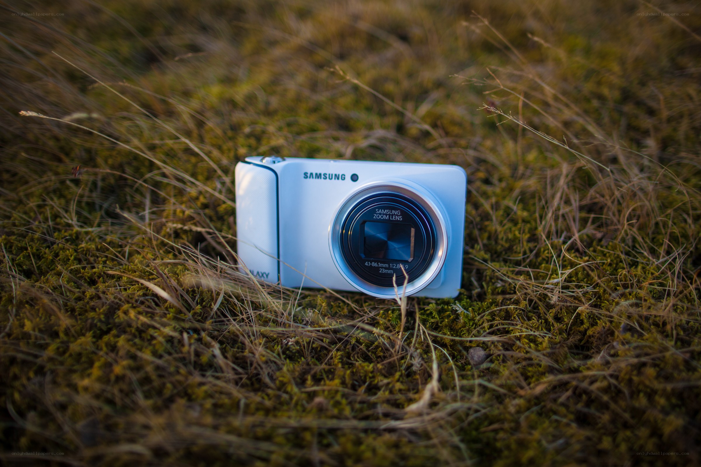 White Samsung camera in grass