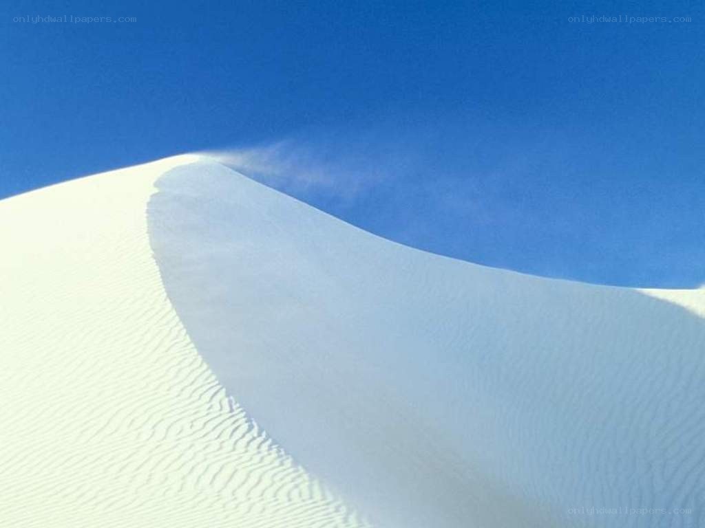 White sand dune under blue sky