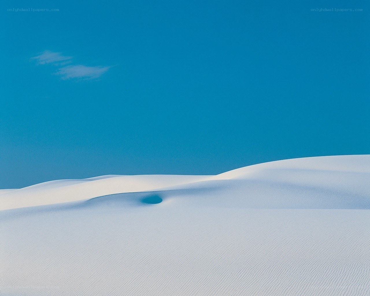White sand dunes under blue sky