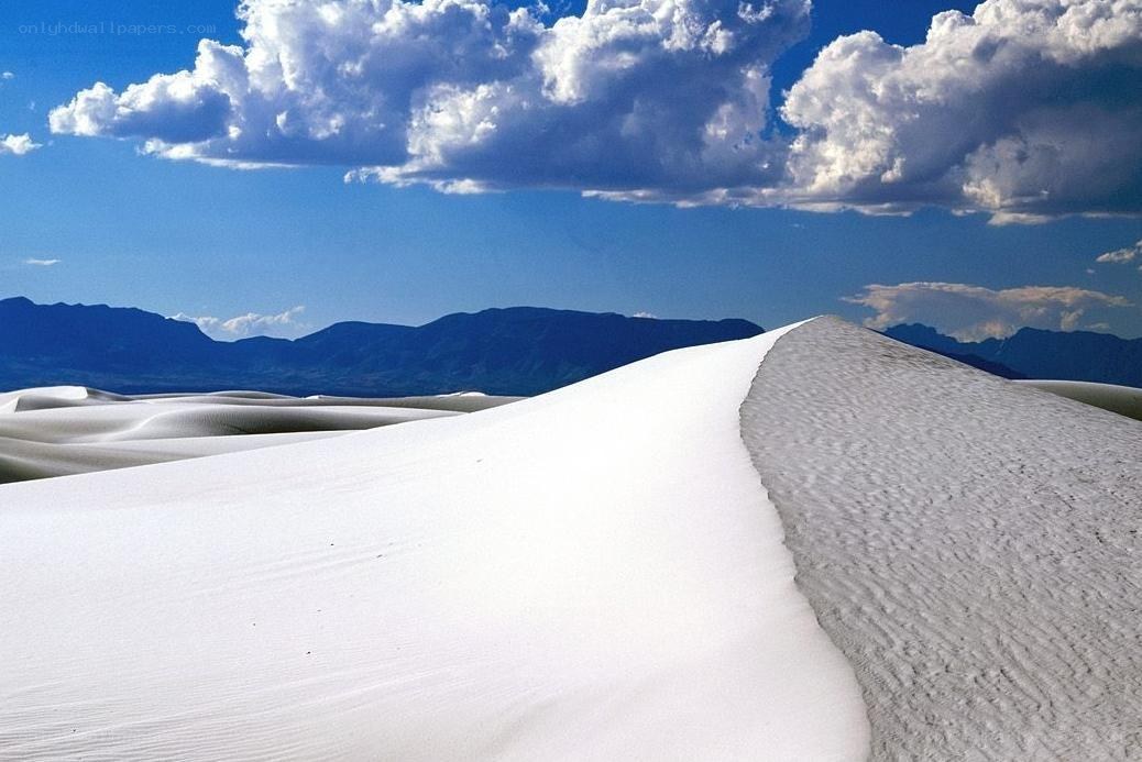 White sand dunes under blue sky