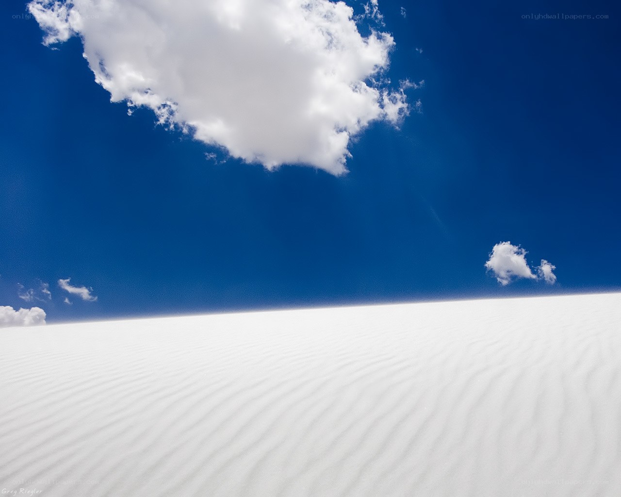 White sand dunes under blue sky