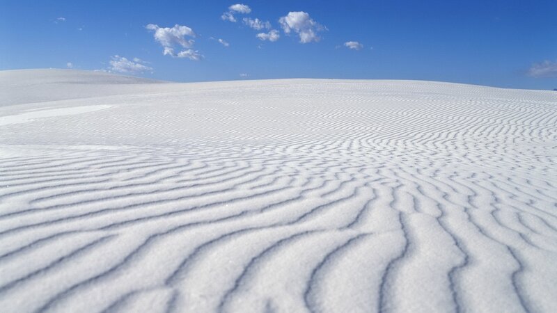 white sand dunes under blue sky