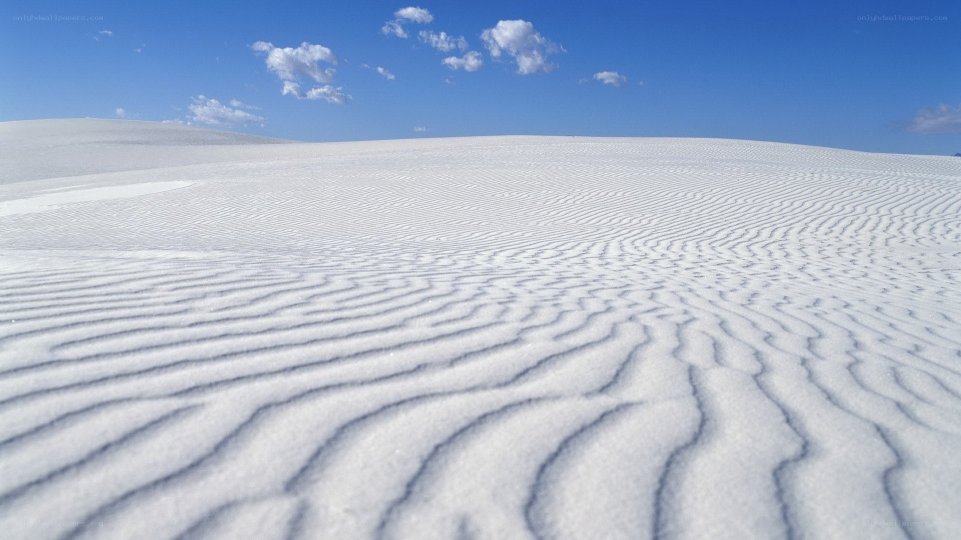 white sand dunes under blue sky