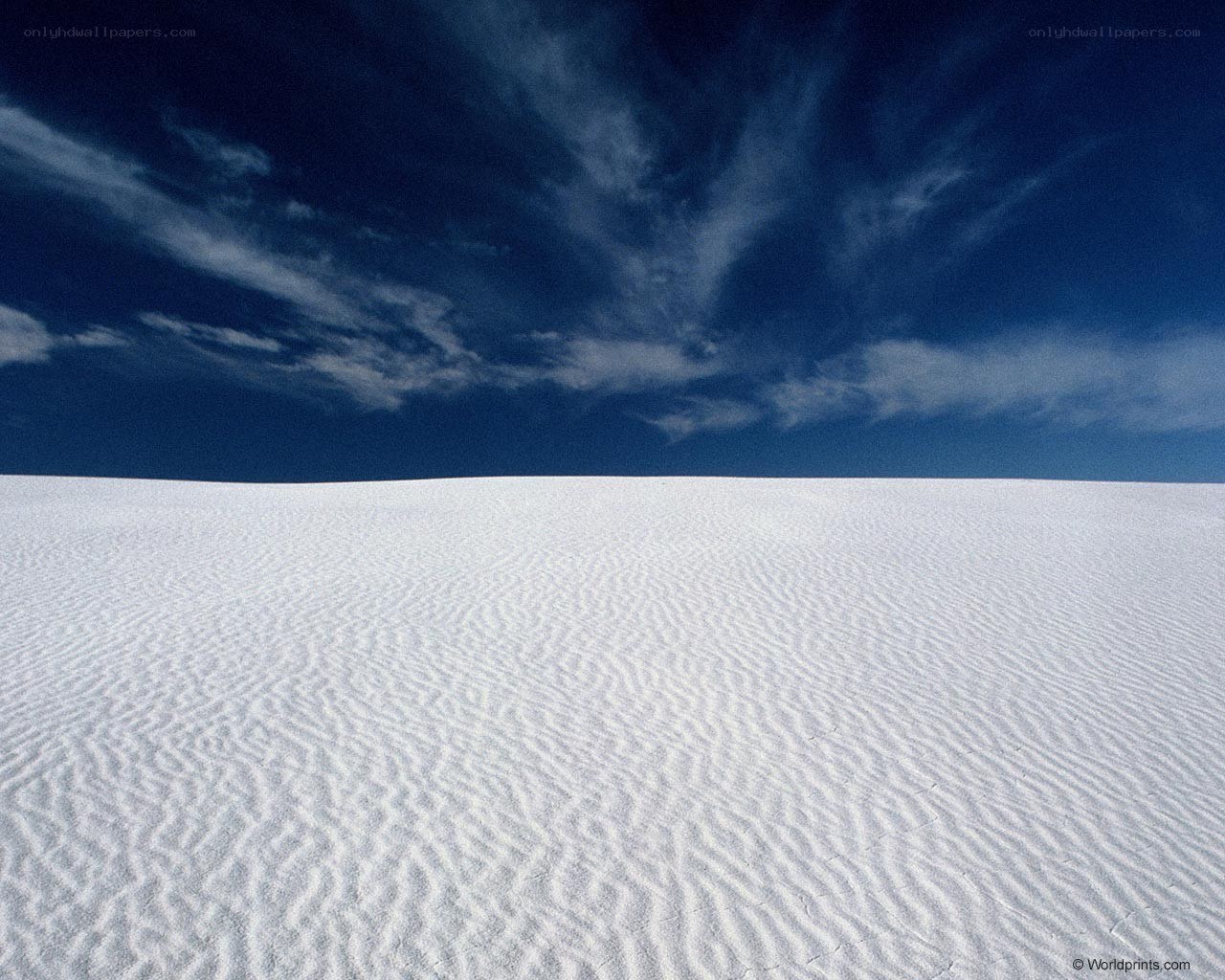 White sand dunes under blue sky