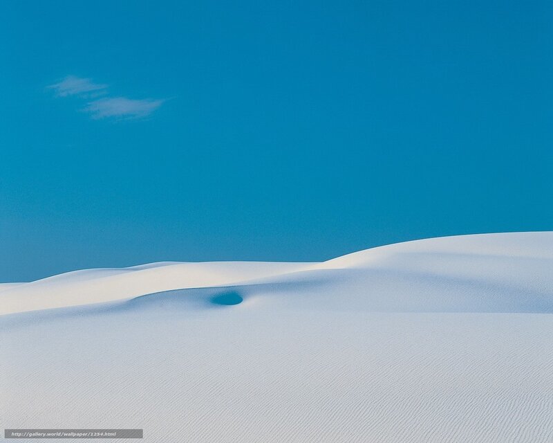 White sand dunes under blue sky