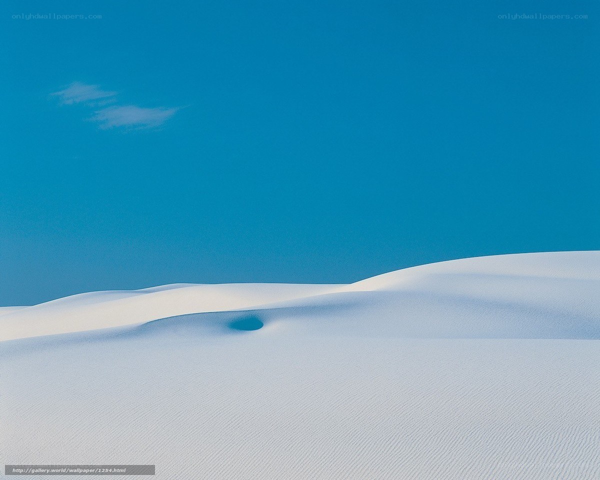 White sand dunes under blue sky