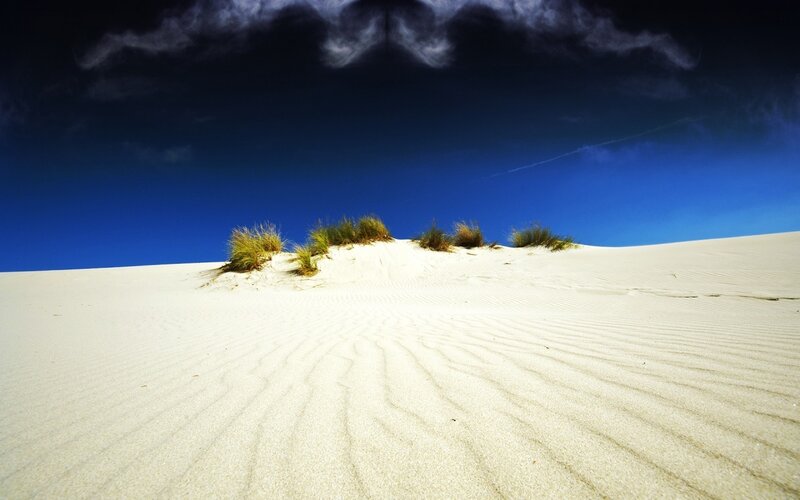 White sand dunes under blue sky