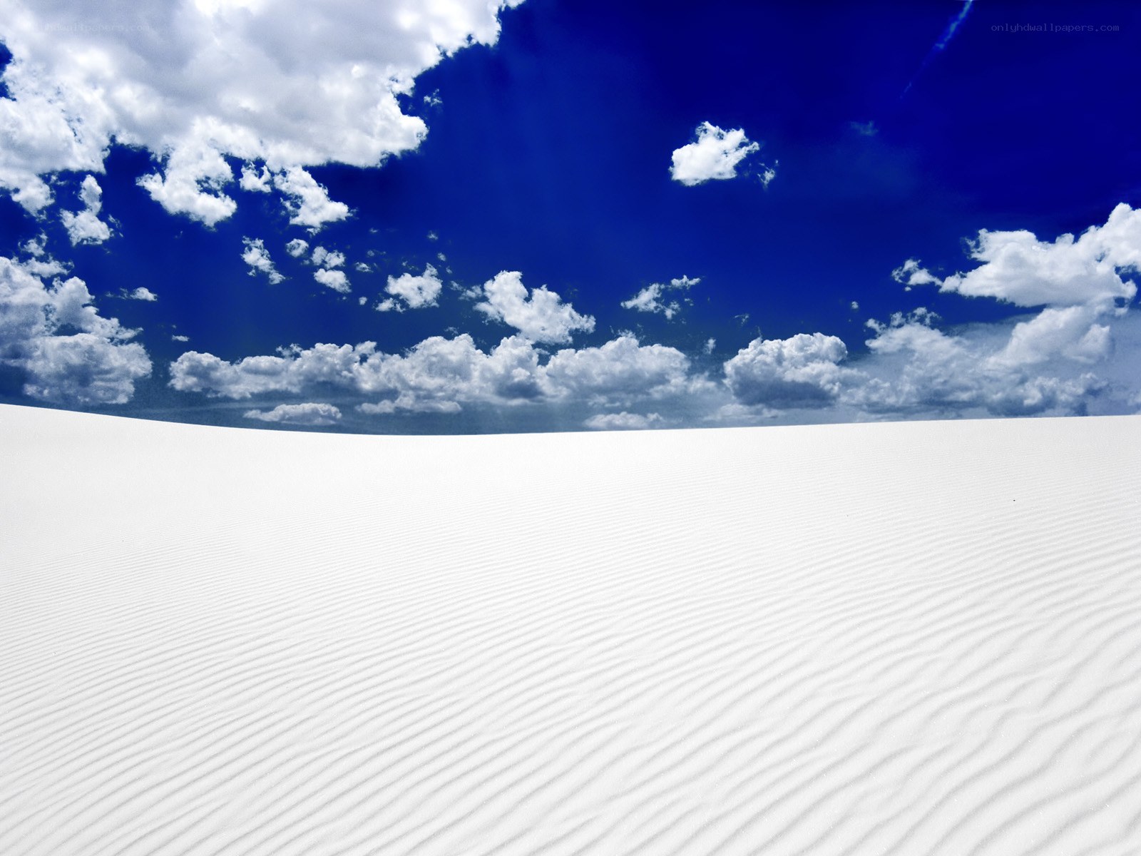 White sand dunes under blue sky
