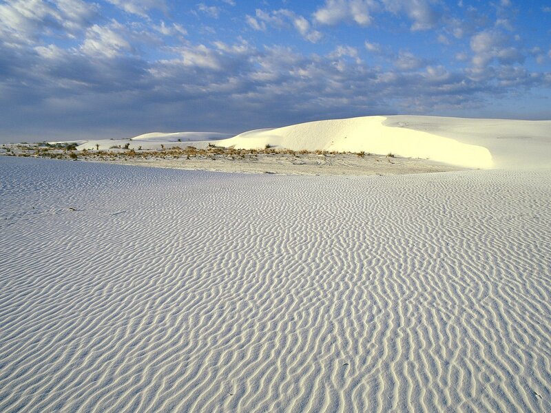White sand dunes under blue sky