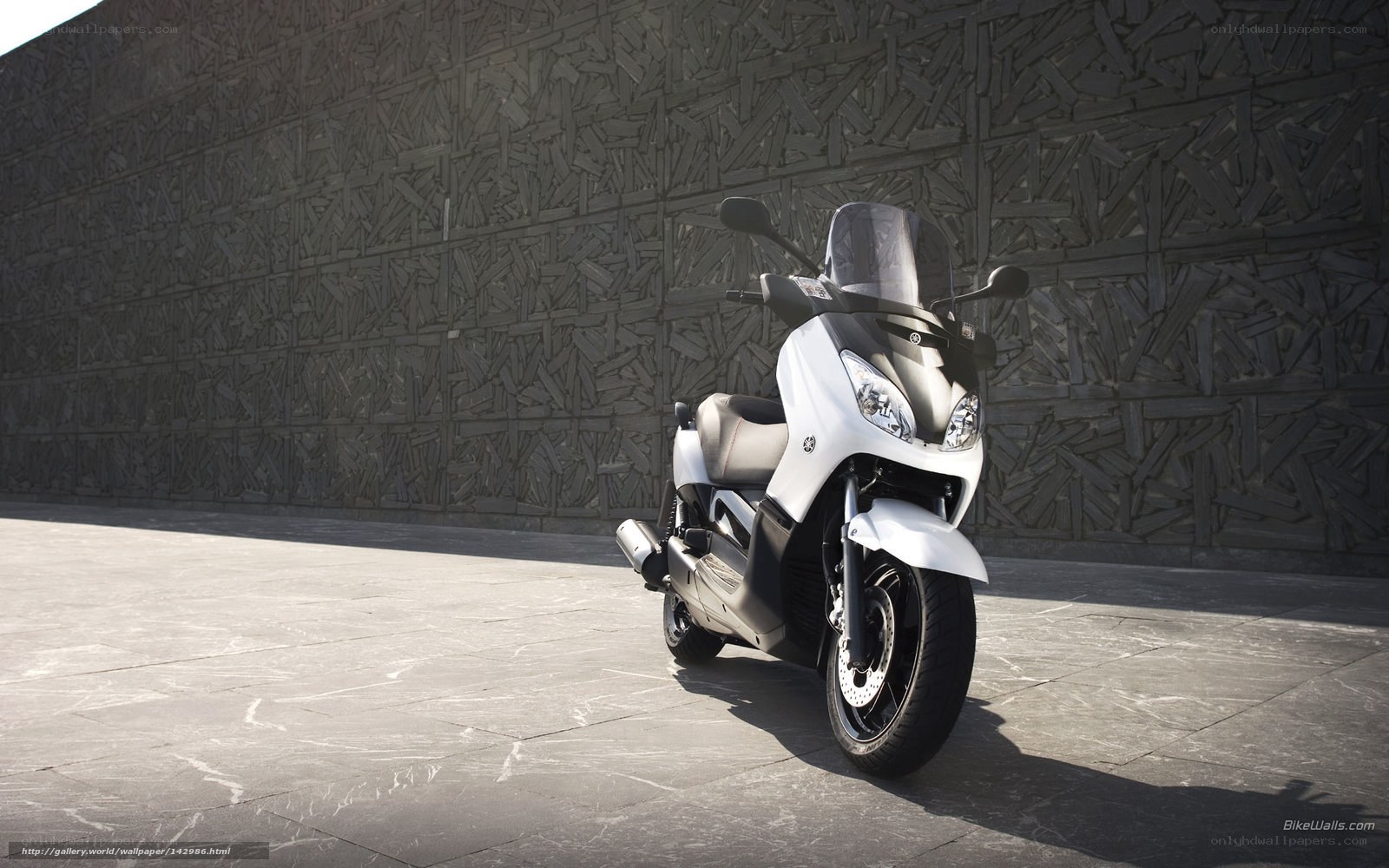 White scooter on stone pavement