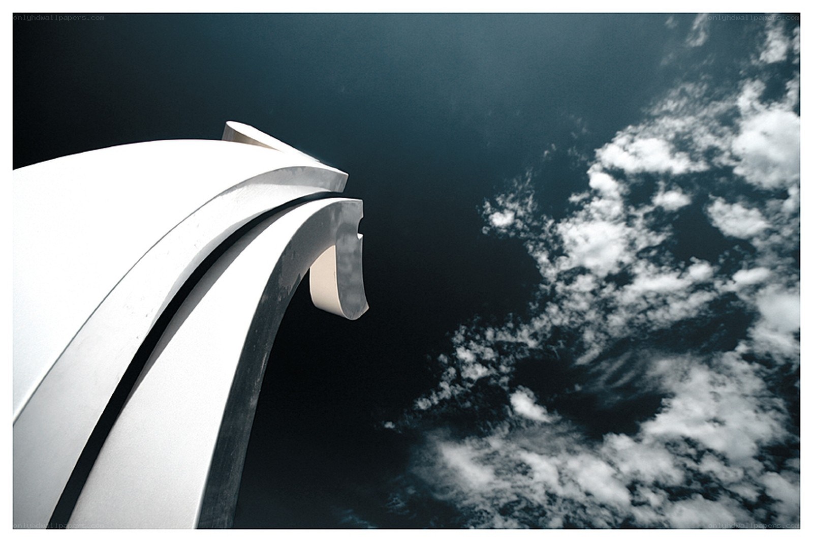 white sculpture against cloudy sky