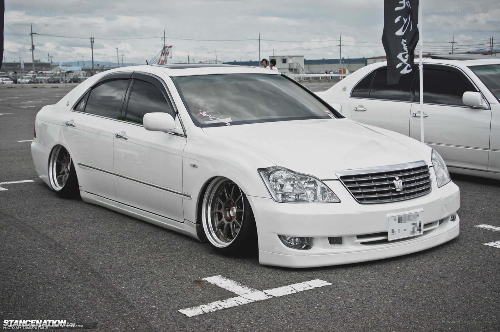 White sedan at car show