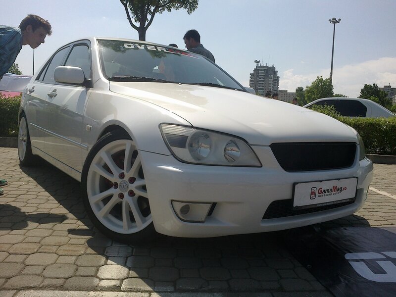 White sedan at outdoor car show