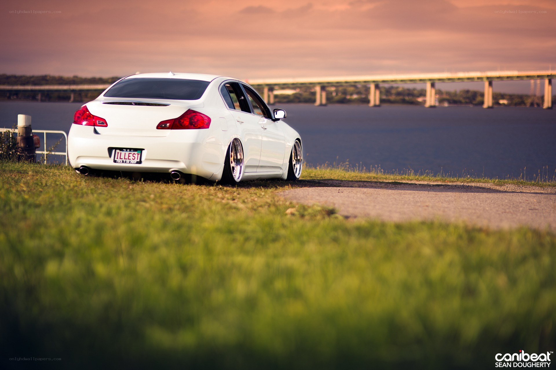 White sedan by the water